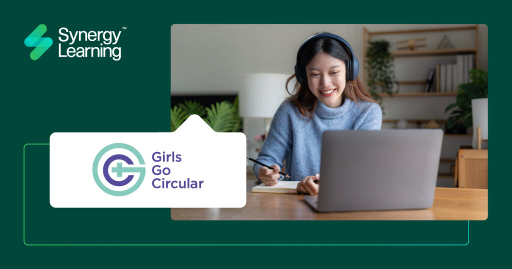 woman smiling while working on a laptop