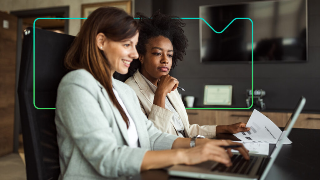 Two women working together on a laptop