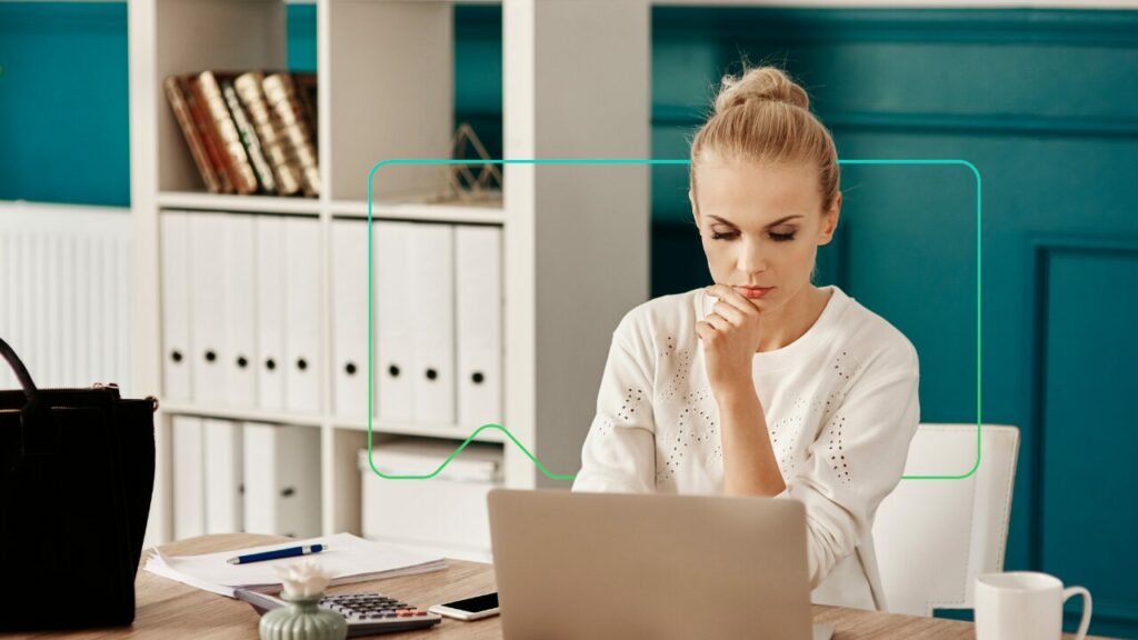 woman working at desk on laptop device